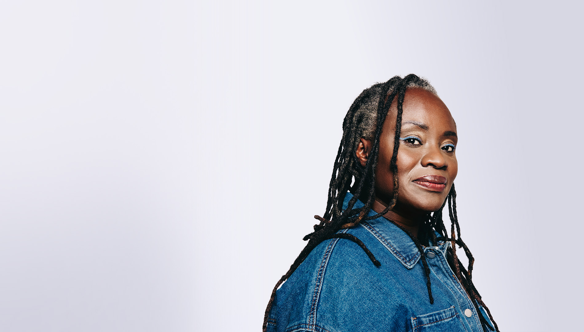 Stylish black woman with dreadlocks looking at the camera