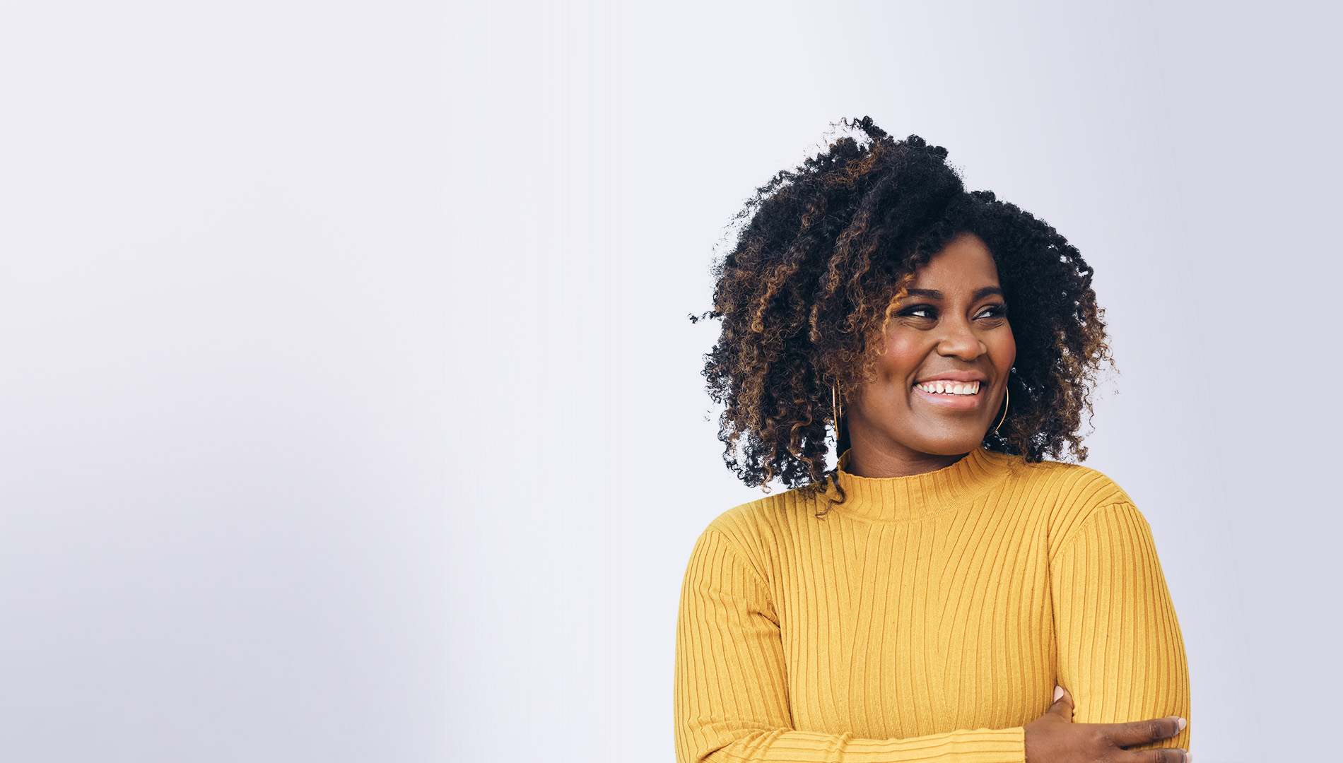 smiling beautiful black woman with arms folded