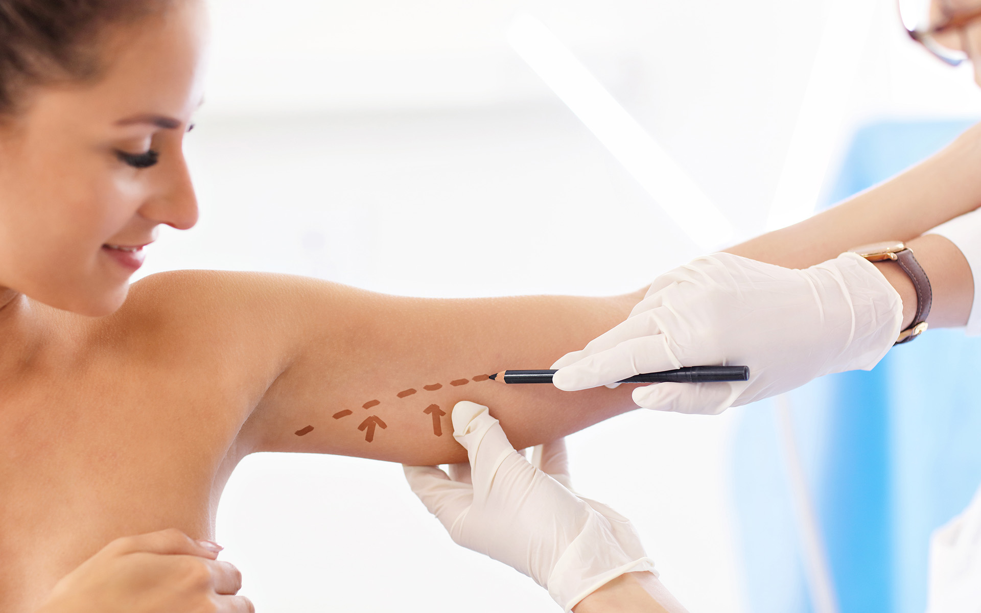 doctor marking womans upper arm