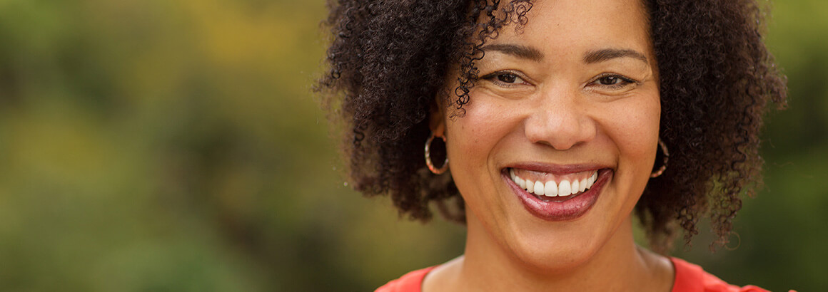 smiling black woman red shirt