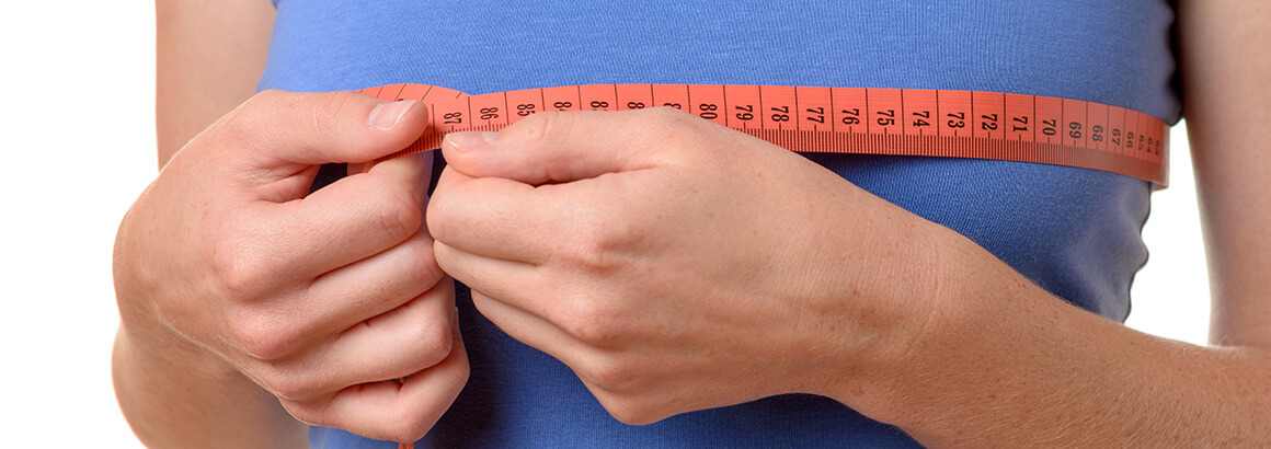 woman with red measuring tape around chest