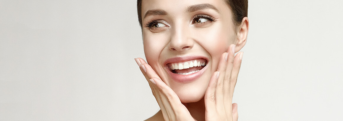 young woman hands on face