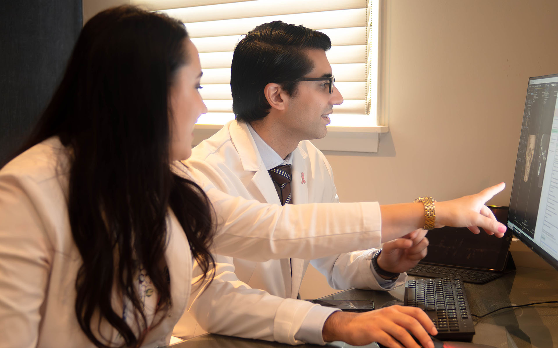 two physicians in office looking at screen-1