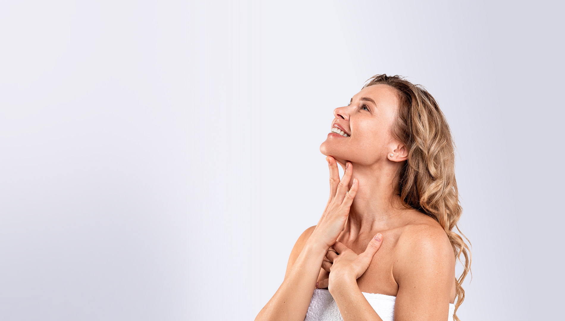 Middle Aged Woman Touching Smooth Skin On Neck