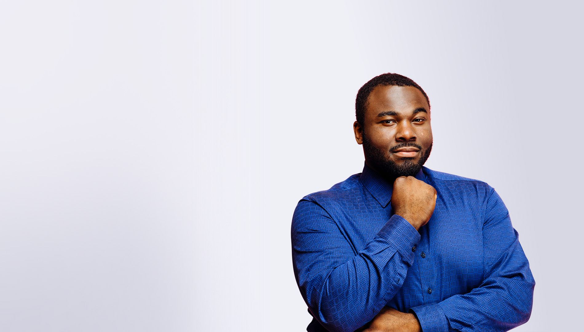 confident heavy black man in casual blue shirt